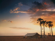 A white guest tent at San Camp glows under a fiery sunset in the Makgadikgadi Pans, Botswana.