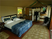 A comfortable bed awaits in a tent at Little Vumbura in the Okavango Delta, Botswana.