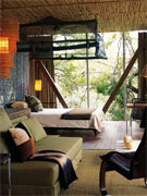 Light floods an airy bedroom at Singita Sweni Lodge, Kruger National Park, South Africa.